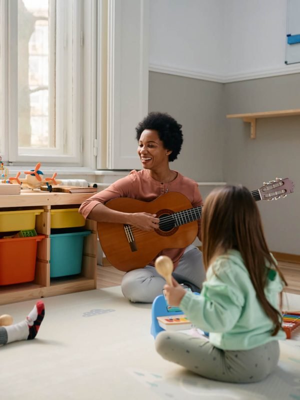 happy-black-teacher-and-group-of-kids-enjoying-during-music-class-at-kindergarten-.jpg